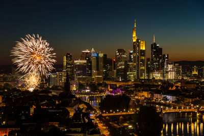 Fireworks mainfest frankfurt in front of illuminated city skyline