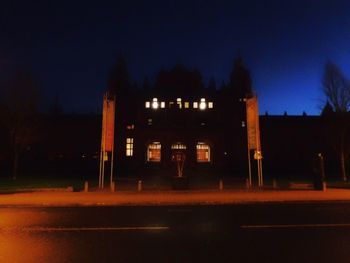 Illuminated building against sky at night