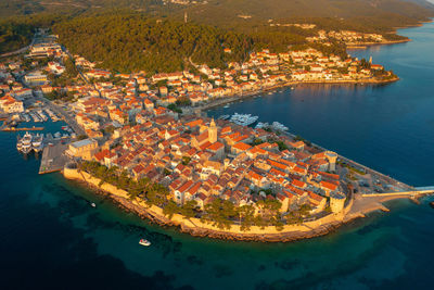 High angle view of sea by buildings in city