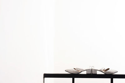 Empty chairs and table against white background