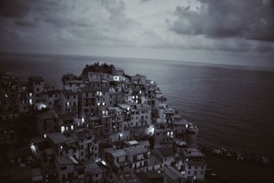 High angle view of townscape by sea against sky