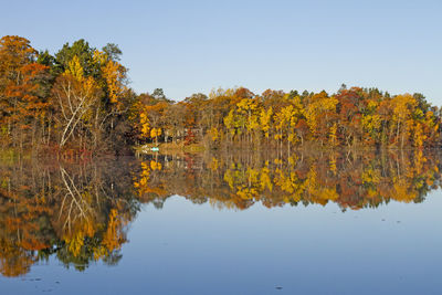 Reflection of trees in lake against sky during autumn