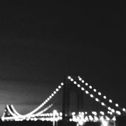 Close-up of illuminated bridge against sky at night