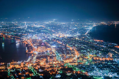 High angle view of illuminated buildings in city at night