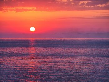 Scenic view of sea against romantic sky at sunset