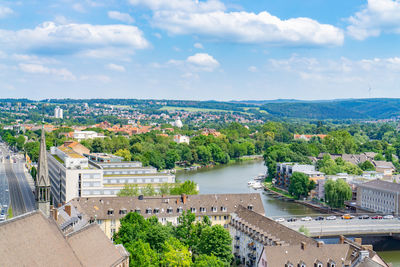 High angle view of townscape by river against sky