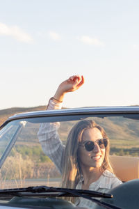 Portrait of young woman in car