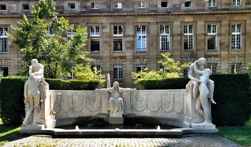 Statue against building in city