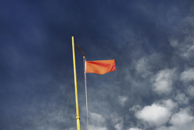 Low angle view of flag against sky