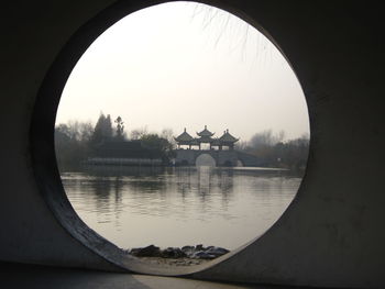 Traditional arch bridge seen through circular window