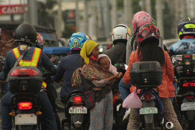 Rear view of people on street