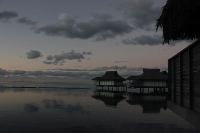 Scenic view of sea against cloudy sky during sunset