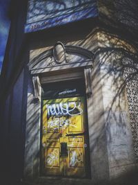 Low angle view of text on wall in old building