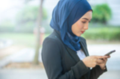 Side view of man using mobile phone