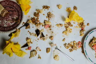 High angle view of food on table - toy soldiers fight in between pieces of cakes