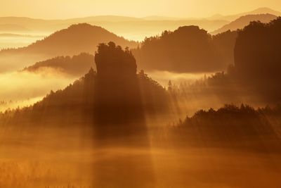 Scenic view of silhouette mountains against sky during sunset