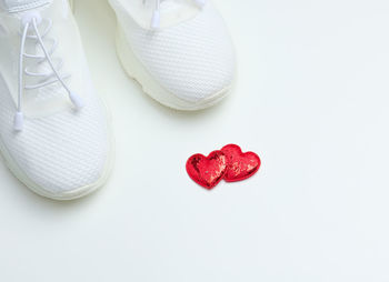 White textile sneakers on a white background, top view
