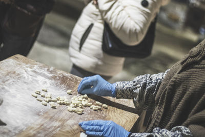 Midsection of person preparing food on table