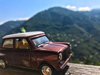 Vintage car against mountain range