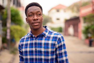 Portrait of young man standing outdoors