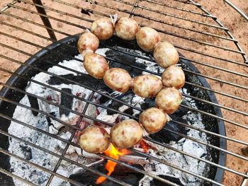 High angle view of meat on barbecue grill