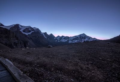 Scenic view of mountains against clear blue sky