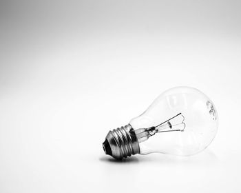 Close-up of light bulb over white background