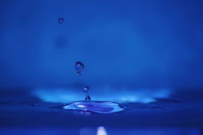 Close-up of drop falling on water surface