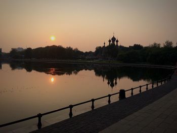 Scenic view of river at sunset