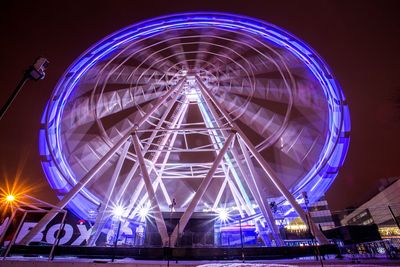 Low angle view of illuminated ferris wheel at night