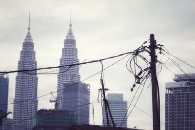 Low angle view of buildings against cloudy sky