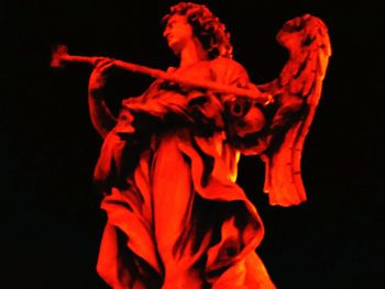 Close-up of red rose against black background