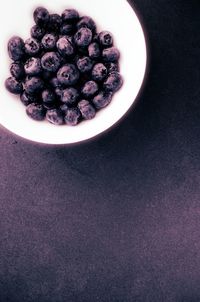 High angle view of purple berries on table