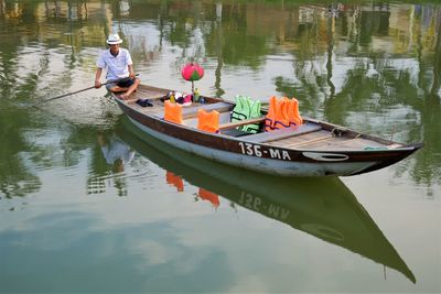 Man sitting on boat in lake