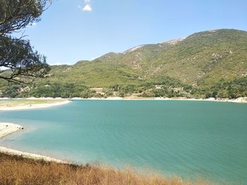 Scenic view of lake and mountains against sky