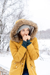 Young woman standing on snow