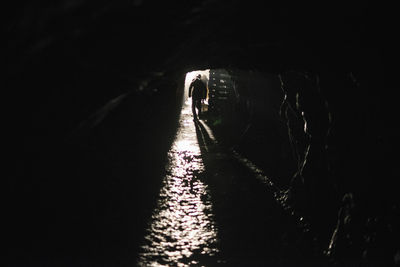 People walking on road in tunnel