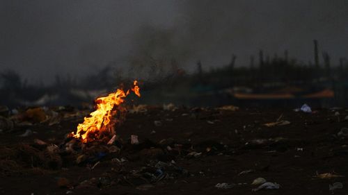 Close-up of bonfire on field at night