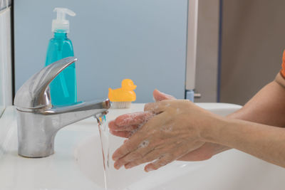 Midsection of man in bathroom at home