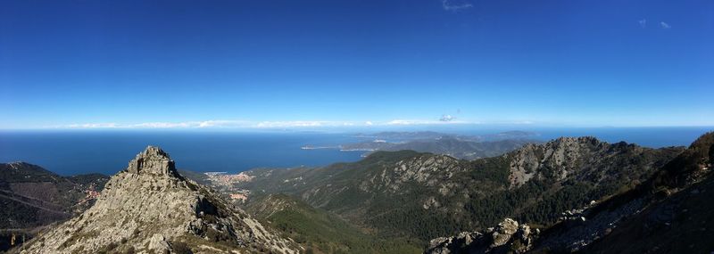 Panoramic view of mountains against blue sky