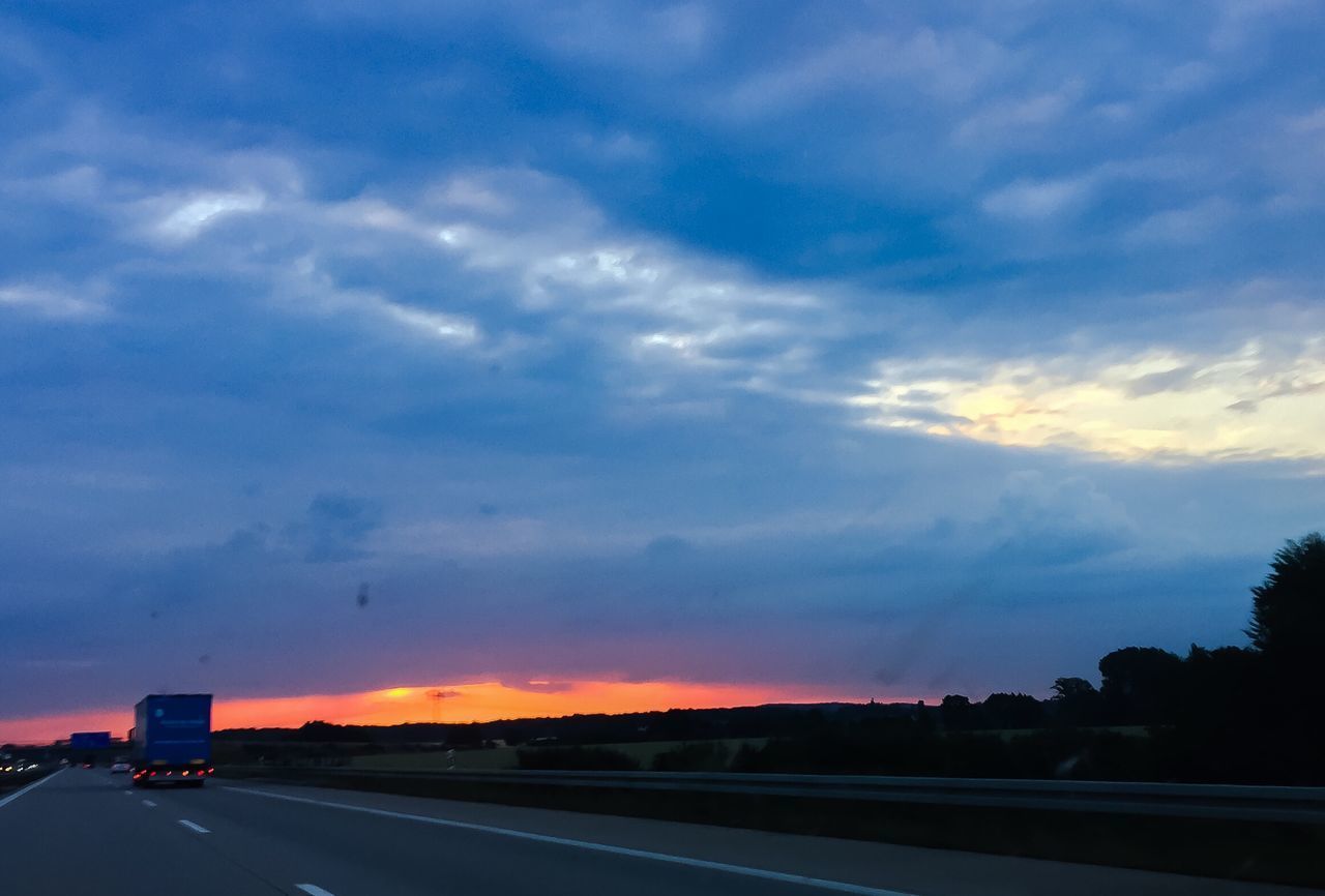 VIEW OF HIGHWAY AGAINST SKY DURING SUNSET