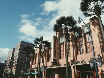 Low angle view of buildings against cloudy sky