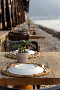 Beautiful served table of a modern cafe by the sea with dishes and flowers