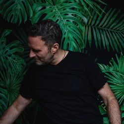 Man standing by plants outdoors