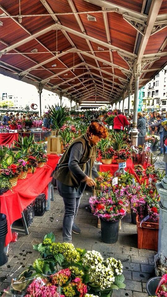 flower, lifestyles, person, men, leisure activity, rear view, casual clothing, freshness, standing, full length, retail, plant, sitting, bouquet, for sale, potted plant, market, market stall