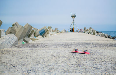 Man on beach against clear sky