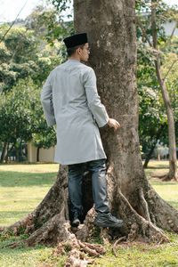 Full length of woman standing in forest