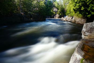 Scenic view of river flowing through rocks