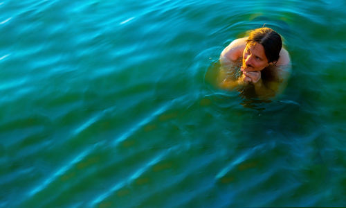 High angle view of woman swimming in sea