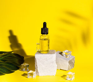 Close-up of yellow bottles on table